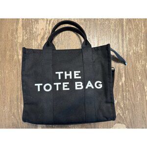 The Tote Bag Crossbody Black White spell out 10x11 inches